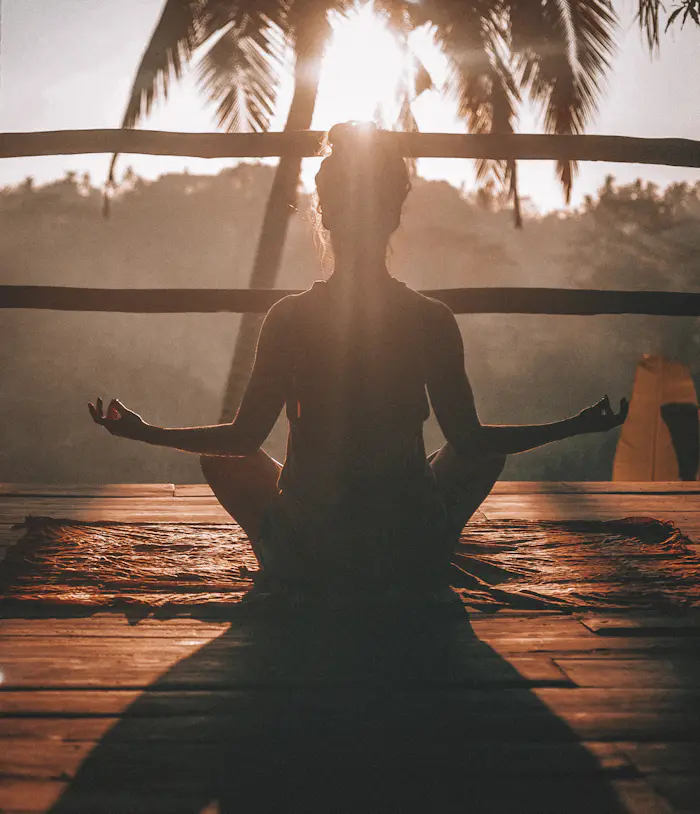 Calm person breathing outdoors with eyes closed in soft natural light
